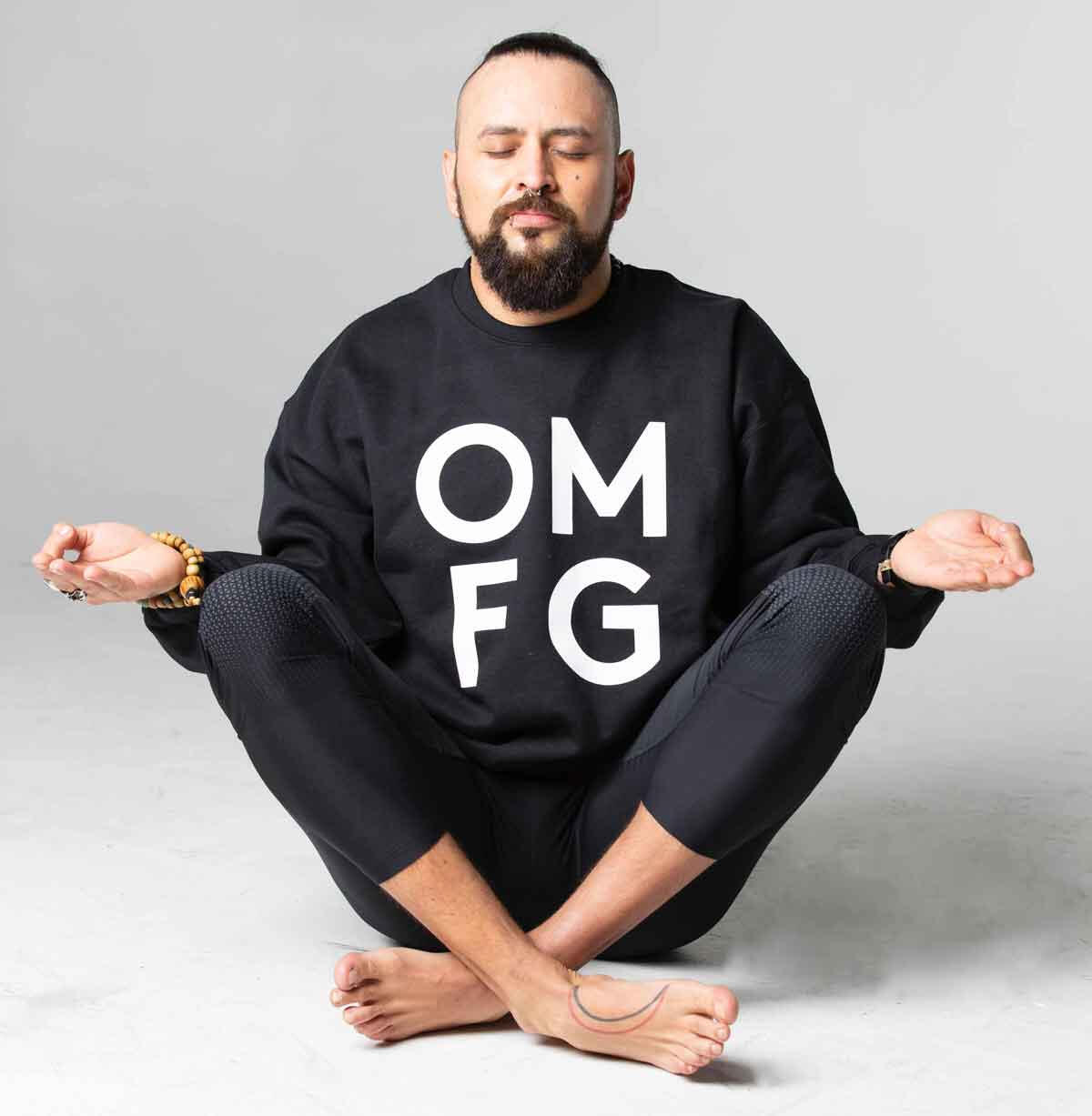 Man sat in sukhasana / easy pose meditating